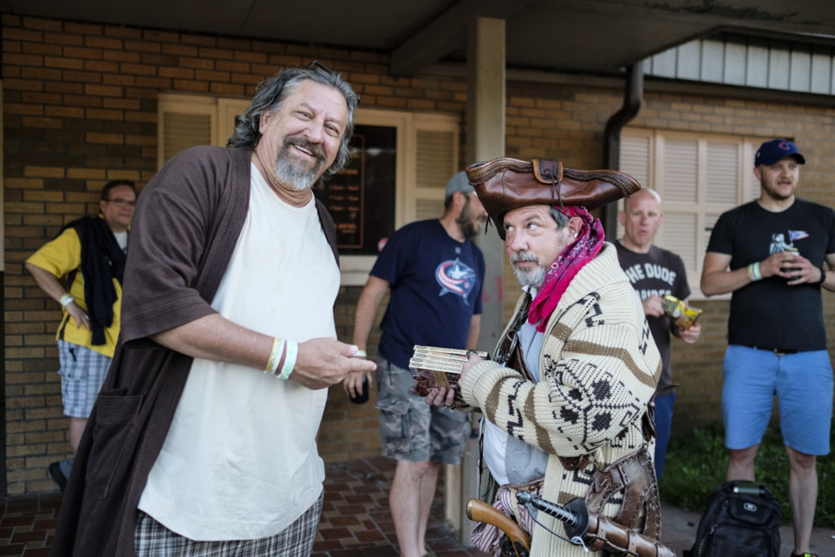 John Kovarik (left) and Brian Scoop Diehl (right) pose for a photo while waiting in line to enter Executive Strike and Spare for the 16th Annual Lebowski Fest in 2017.