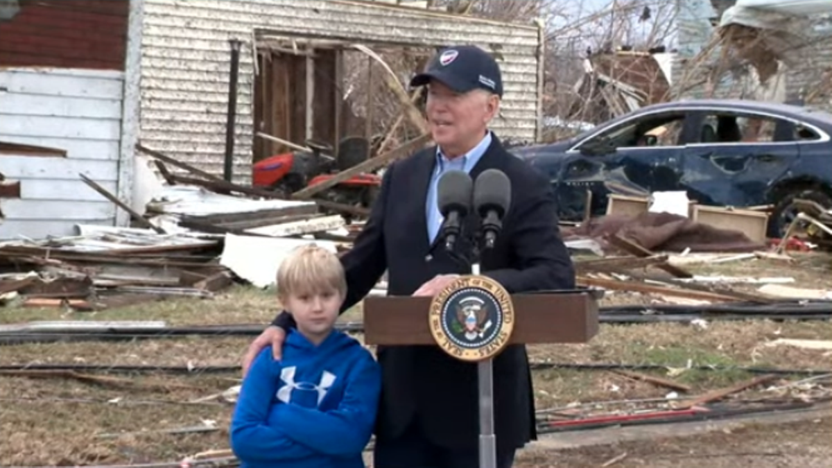 President Joe Biden speaks with Dane, a Dawson Springs resident, by his side during a December 2021 visit to Western Kentucky to survey tornado damage.