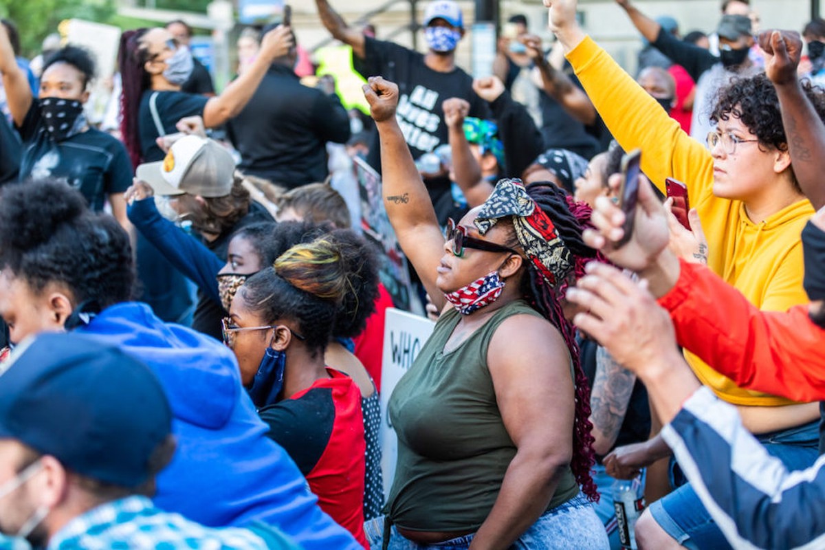 Protesters raised their fists in solidarity during a protest in May of 2020.  |  Photo by Kathryn Harrington.