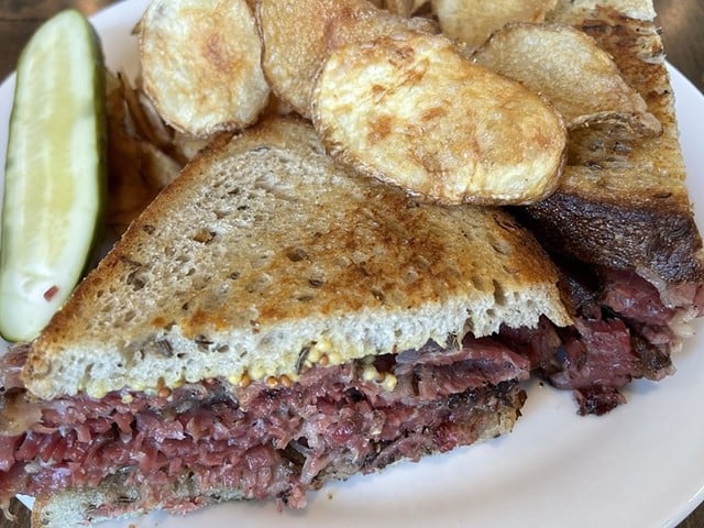 A traditional combination of thin-sliced house-made pastrami and corned beef piled high on rye toast elevates this memorable deli sandwich.