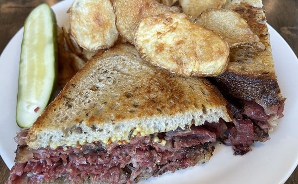 A traditional combination of thin-sliced house-made pastrami and corned beef piled high on rye toast elevates this memorable deli sandwich.