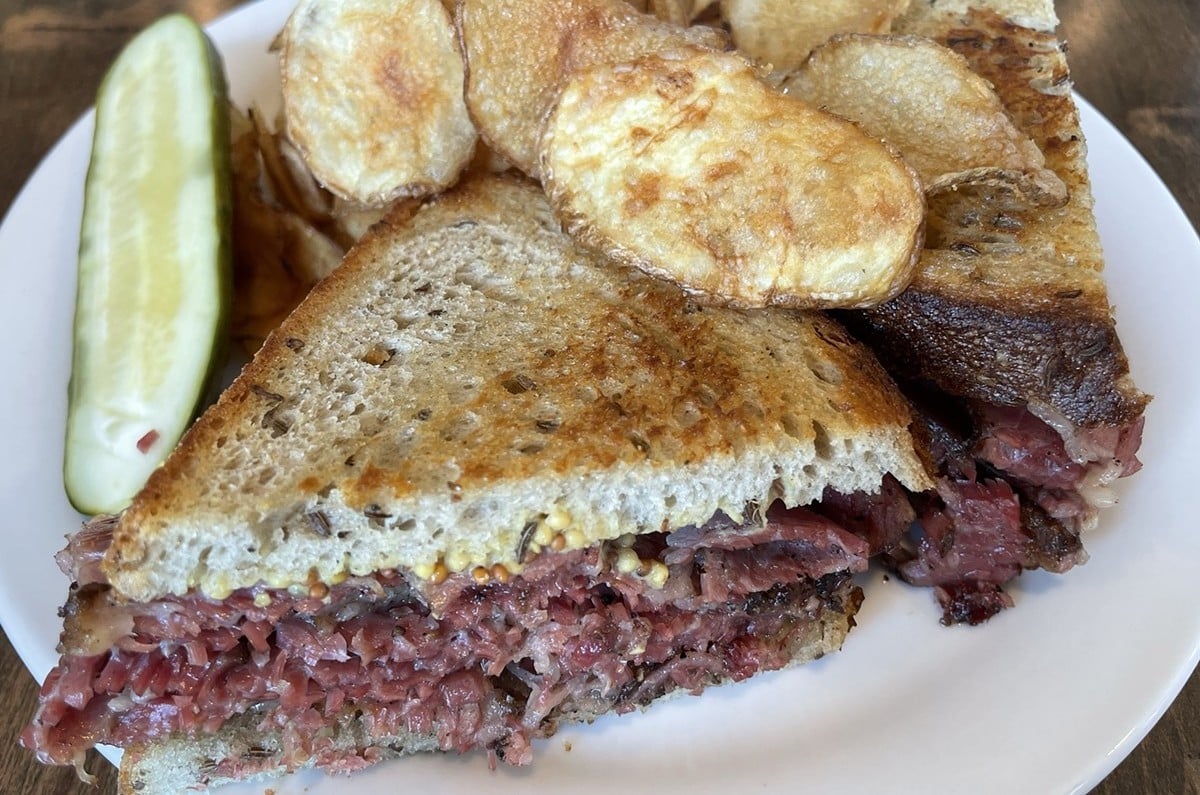 A traditional combination of thin-sliced house-made pastrami and corned beef piled high on rye toast elevates this memorable deli sandwich.