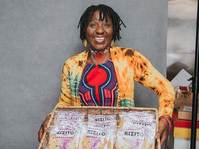 Owner of Kizito Cookies in Louisville, Kentucky holds large box of cookies