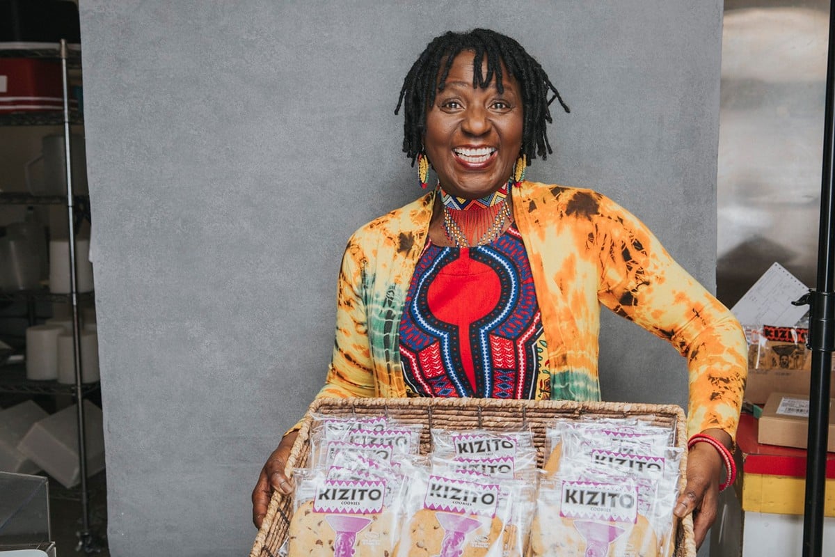Elizabeth Kizito holds box of Lucky in Kentucky Cookies