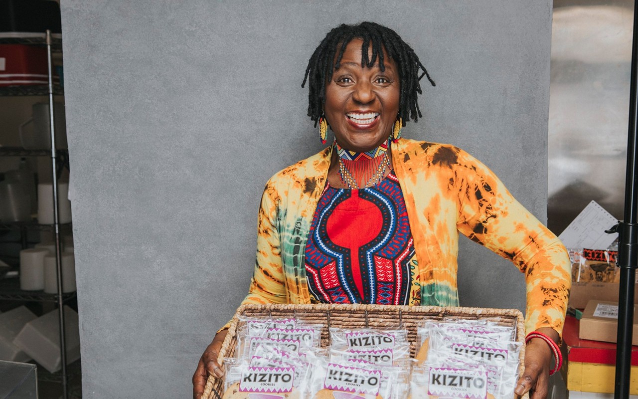 Owner of Kizito Cookies in Louisville, Kentucky holds large box of cookies