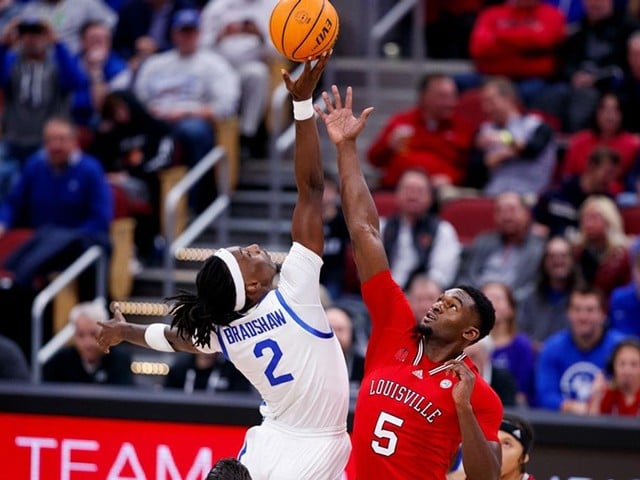 Brandon Huntley-Hatfield fights for the ball at tipoff against UK at the KFC Yum! Center on Dec. 21, 2023.