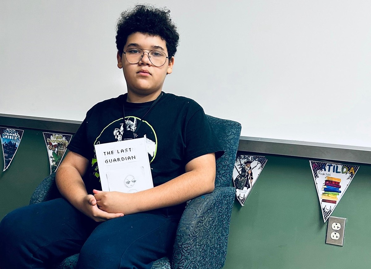 Young writer (not part of contest) holding book