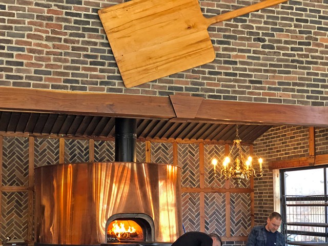 MozzaPi&#146;s bright brass pizza oven turns out excellent pies with its fierce wood fire.