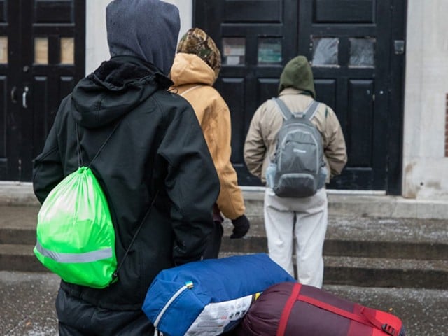 People lining up outside the St. John Center for Homeless Men in January of 2021.