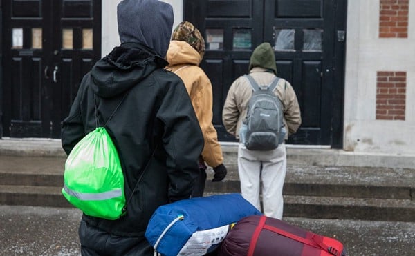 People lining up outside the St. John Center for Homeless Men in January of 2021.