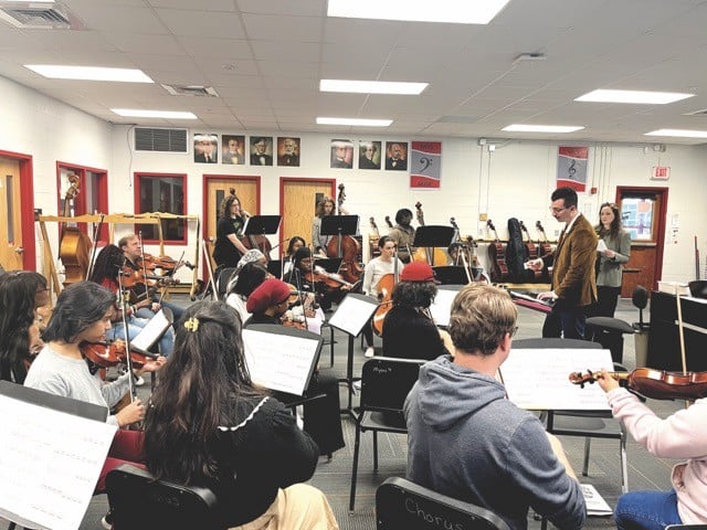 Composer Tanner Porter talking to the the Waggener High School orchestra in March rehearsal.