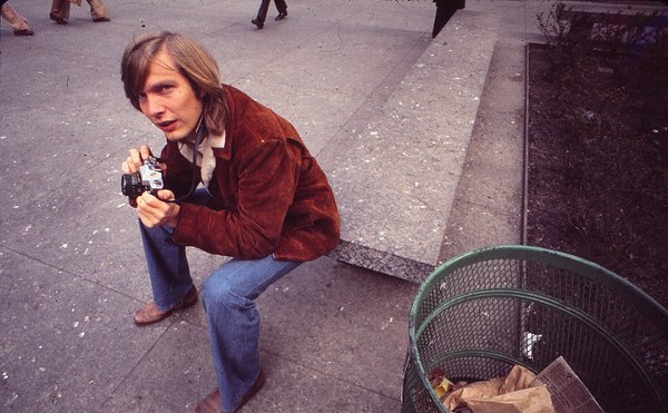 Former Morning Edition Anchor Bob Edwards wearing a brown leather jacket and sitting on a Chicago street in 1974.