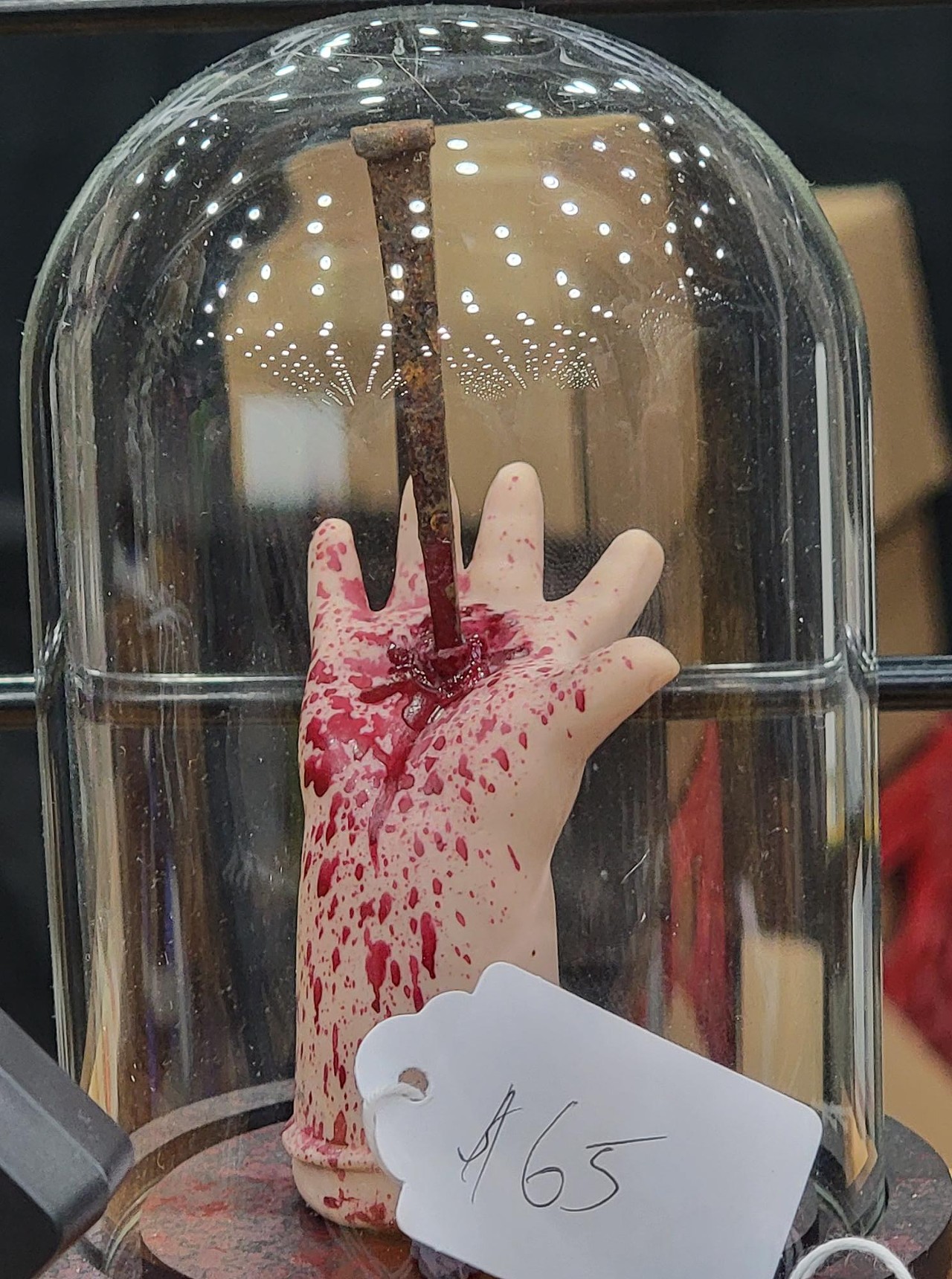 bloody doll hand with nail