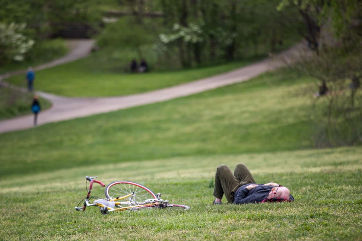 A cyclist takes a break in Cherokee Park.