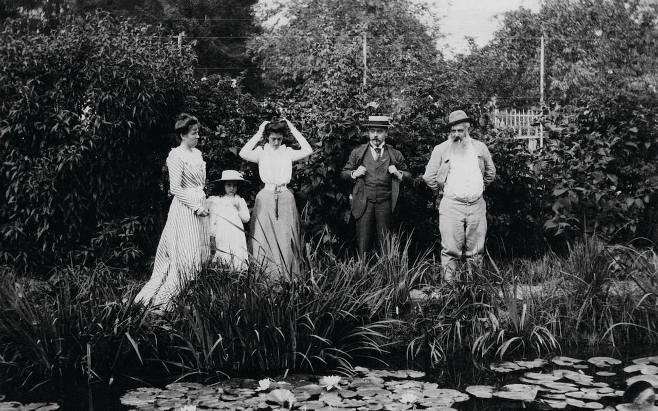 Claude Monet (far right) in his garden at Giverny, France.