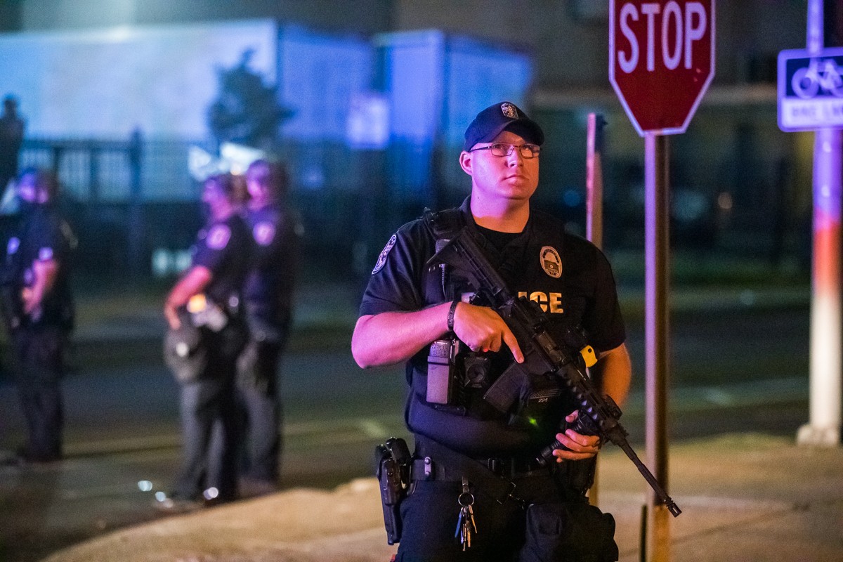 LMPD officers stood by as several protesters were arrested for being out past curfew. - KATHRYN HARRINGTON