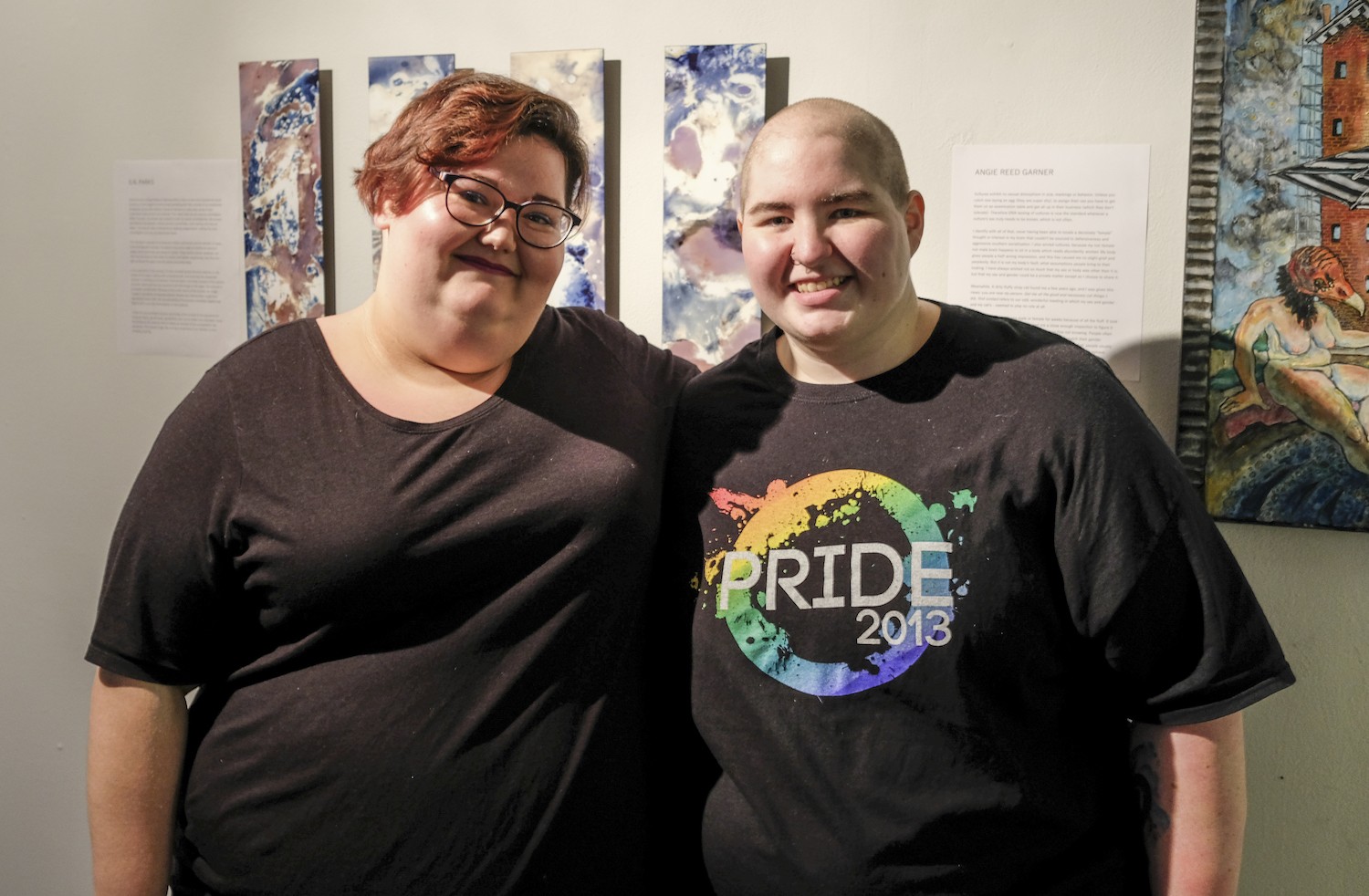 S.N. Parks (left) stands beside their partner MC Lampe (right) at the Queer Voices 2017 art exhibit. Not only is Parks one of the fourteen artists in the exhibit, they are also one of the curators of the show.