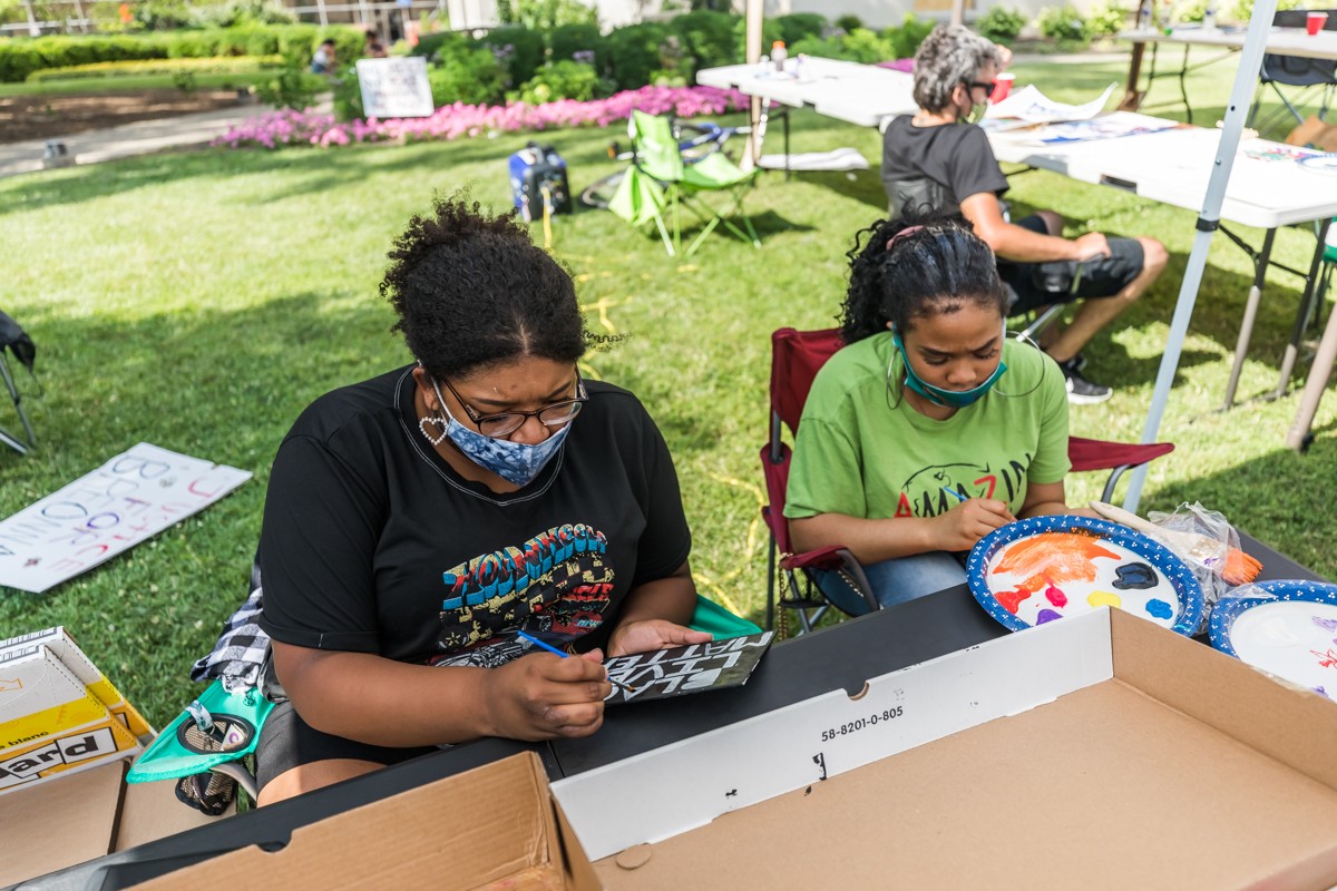 Ariana Tulay and Olivia Benford worked on paintings at the event - in Jefferson Square Park on Saturday. - KATHRYN HARRINGTON