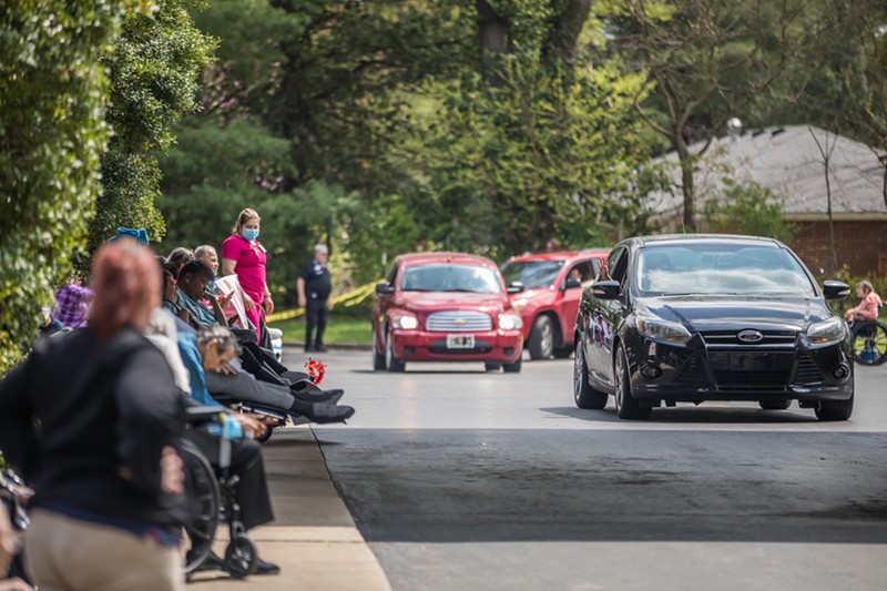Residents and patients at Signature HealthCARE at Jefferson Manor Rehab lined up on both sides of the drive, waiting to see family members drive through. - KATHRYN HARRINGTON