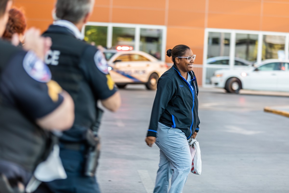A Norton Audubon healthcare worker was greeted with applause from Louisville police officers and fire fighters as she ended her shift. - KATHRYN HARRINGTON