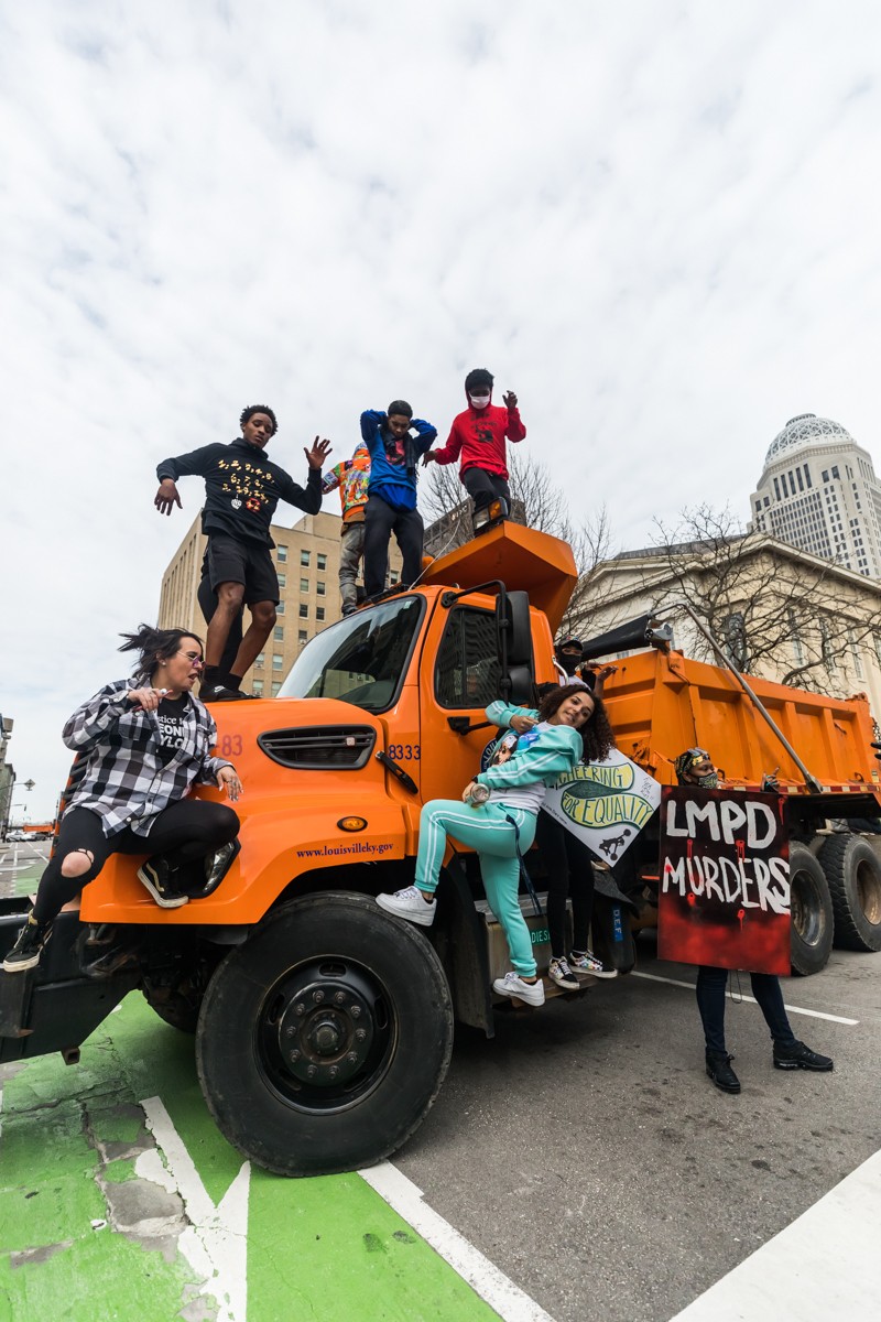Protesters climbed on top of one of the dump trucks used to block off traffic around the Square. - KATHRYN HARRINGTON