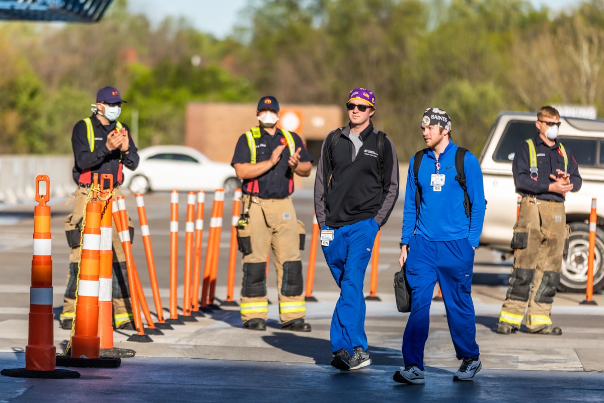 Norton Audubon healthcare workers arrived for their shift on Tuesday to applause and statements of grattitude from Louisville fire fighters and police officers. - KATHRYN HARRINGTON