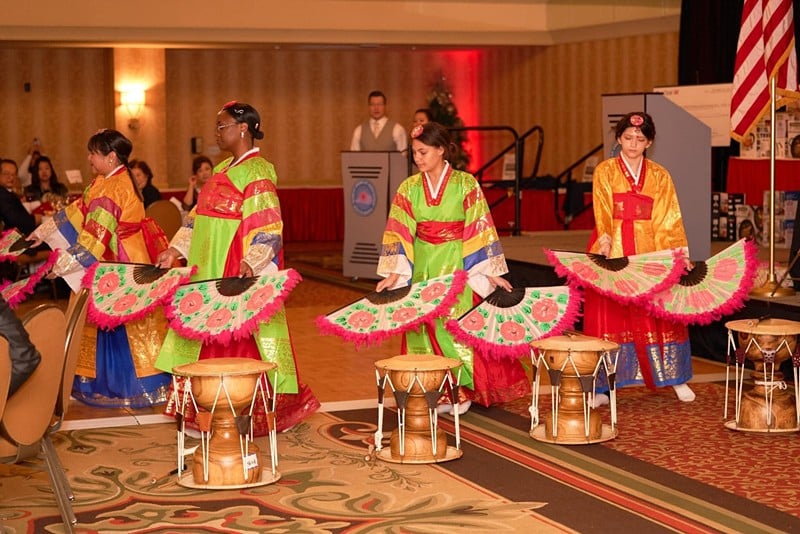 Adult students of Korean School of Louisville perform a fan dance at a Korean holiday event.