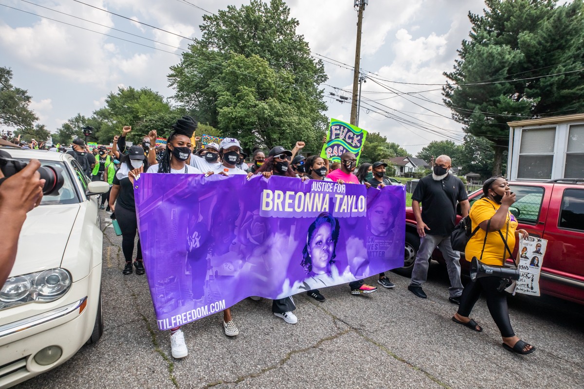 Protesters marched from South Central Park to the Central Avenue Bridge on Tuesday. - KATHRYN HARRINGTON