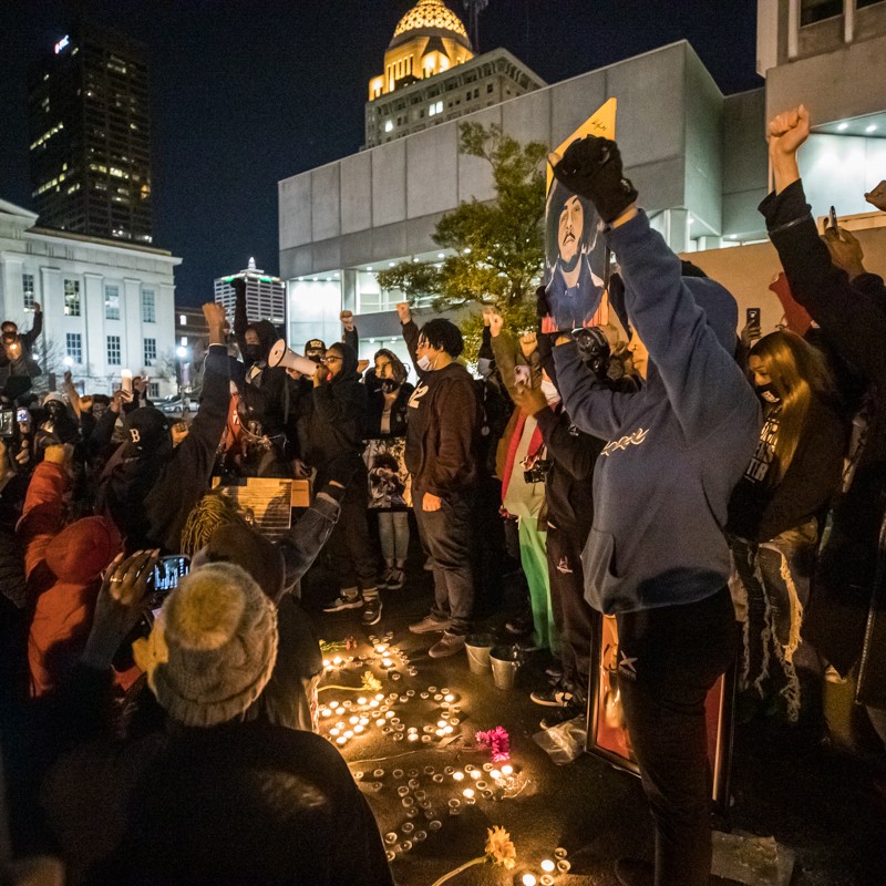 Mourners raised their fists and chanted in honor of Travis Nagdy at Jefferson Square Park. - KATHRYN HARRINGTON