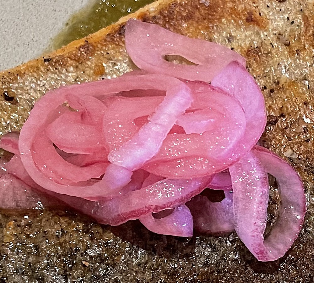 A pile of pickled red onions as garnish on a Riverence salmon fillet at Barn 8 triggered our food critic's musings on food trends that come and go.