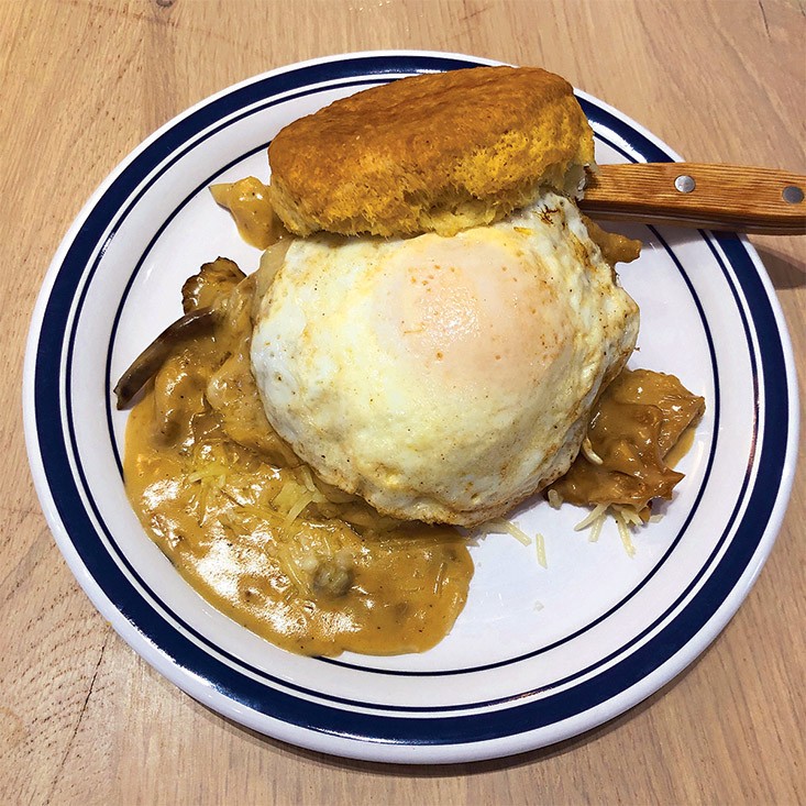 Biscuit Belly&#146;s Edgy Veggie stacks an egg, cheese, and fried green tomato on an oversize biscuit bathed in thick mushroom gravy.