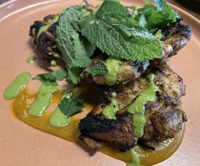 PHOTO: Shawarma spiced chicken thighs were tender, juicy, and crisp, elevated with Levantine spices and perched on a schmear of pale-green shug, a fiery Yemenite condiment that Meesh Meesh makes with jalape&ntilde;os.