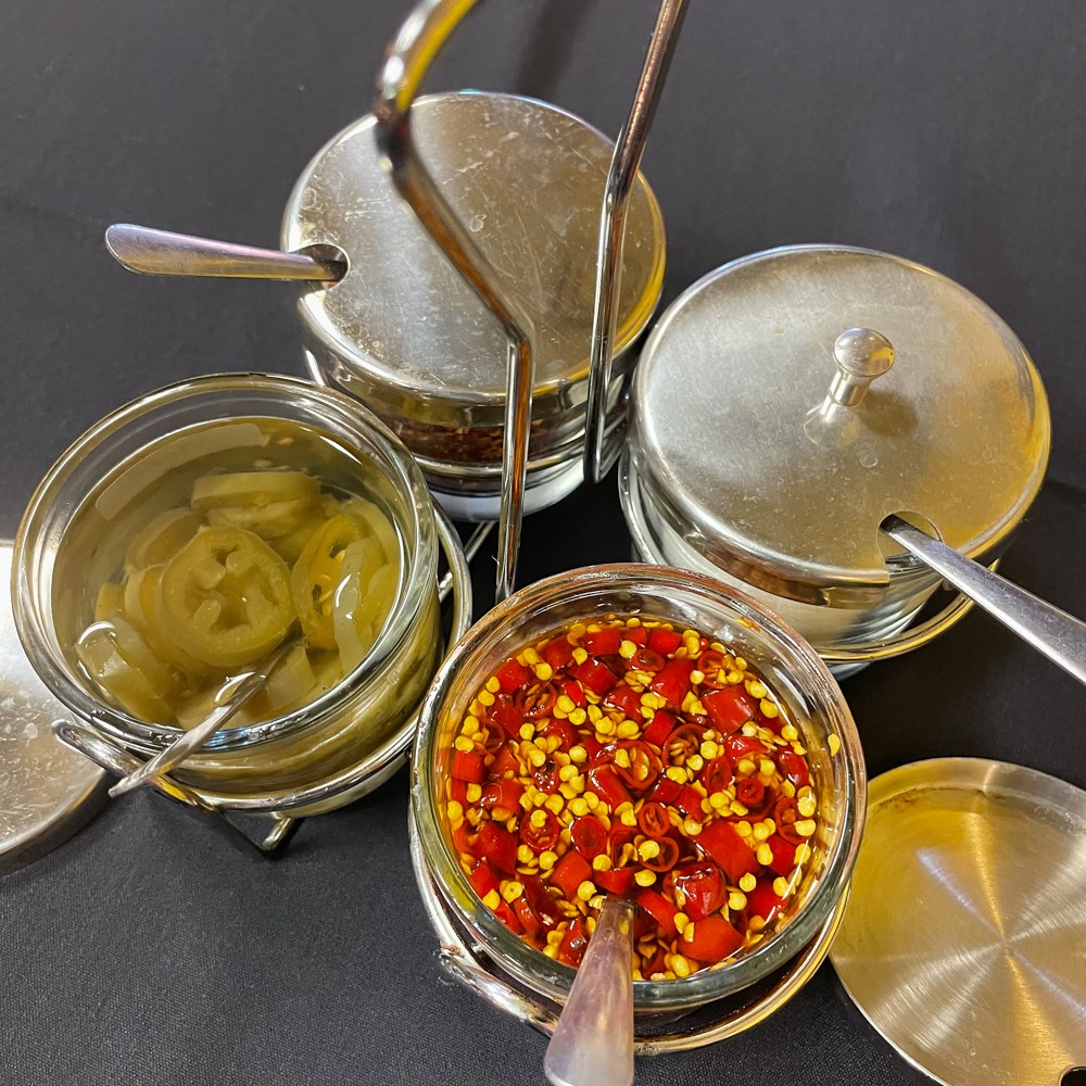 Only a few of All Thai'd Up's dishes are marked with chili peppers denoting hot-and-spicy flavor, but every table gets a set of four fiery condiments so you can have it your way.