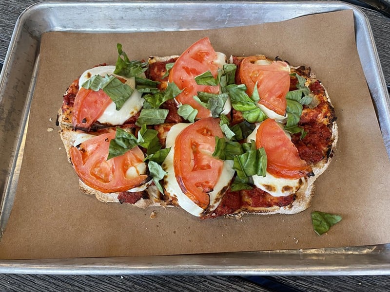 Banditz Pizza's margherita pie is built on an oval base of fresh, crisp flatbread and topped with the traditional tomatoes, mozzarella, and basil. - Robin Garr
