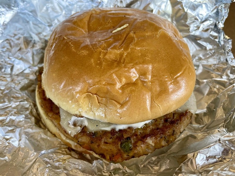 The California burger from Bunz Burger in The Village Market Food Hall, comes with a slice of Swiss on a golden bun slathered with just enough guacamole and mayo to make it a slippery experience. - Robin Garr