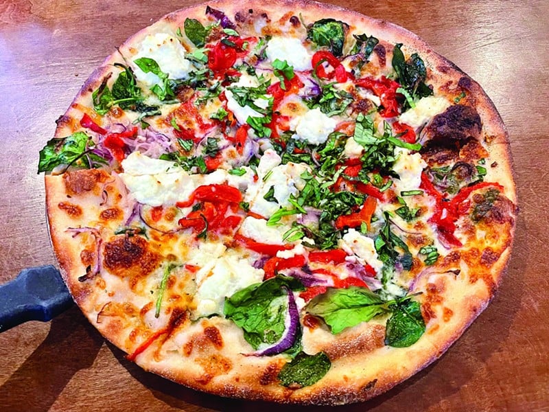 The White Flag, one of The Post's dozen standard pies, is an appetizing Mediterranean-style mix of red onion, spinach, and roasted red pepper on a garlic olive oil base, dotted with bites of ricotta and snipped fresh basil. - garr