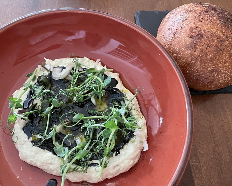 Silken chilled artichoke dip buzzed with pickled ramps and topped with a pool of black tahini and pea tendrils came with a stunningly good warm mini-loaf topped with peppery spice. - Robin Garr