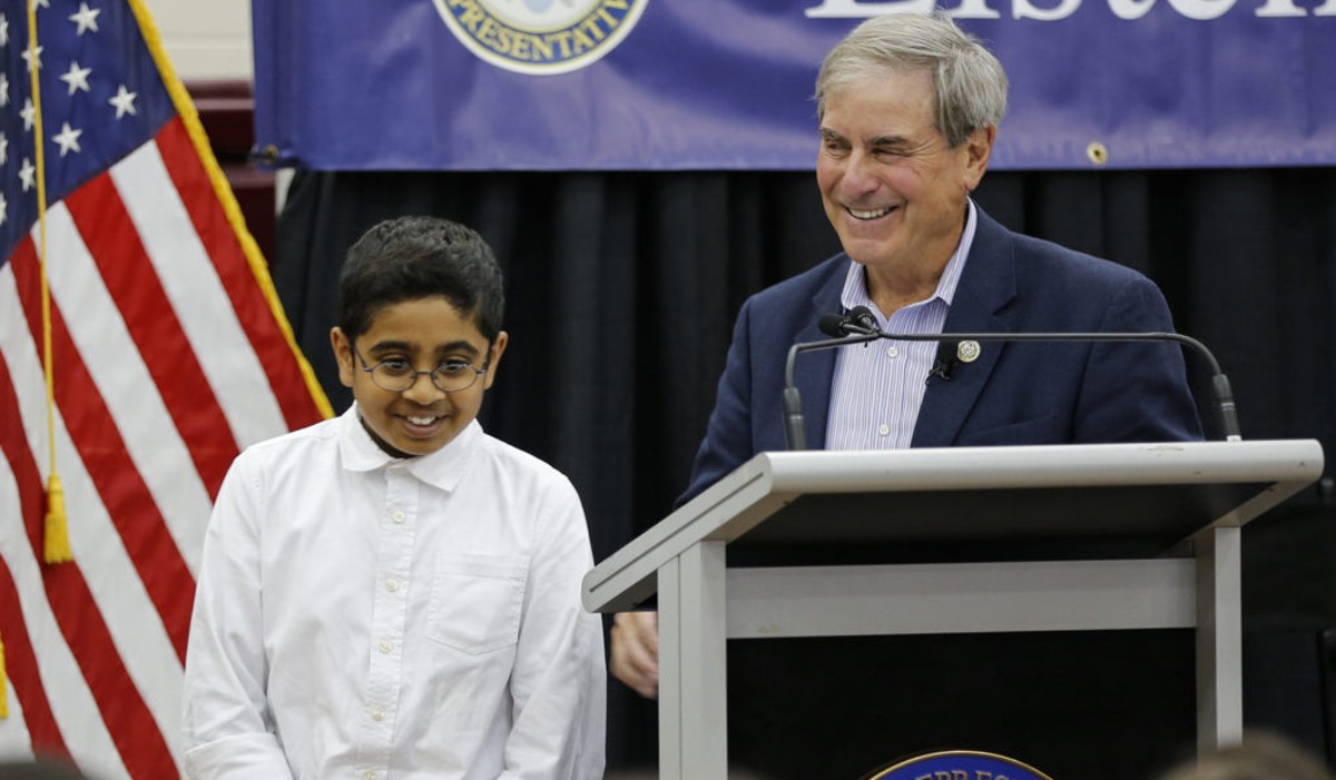 Eleven year old Pavan Venkatakrishnan walks off the stage after speaking at the podium during the Q&A portion of the Town Hall.  Venkatakrishnan applauds the ACA, and states that it is "an amazing bill with so many provisions that help so many people", but he asks "Why didn't Democrats do a better job of marketing the bill?"