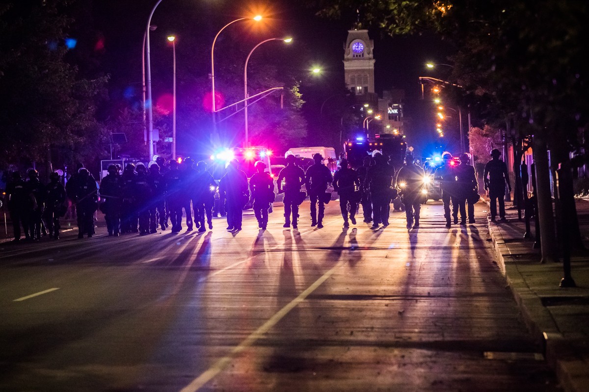 Police made their way down 6th Street as they followed protesters who were leaving 
    the square shortly after curfew on Saturday.  |  Photos by Kathryn Harrington.