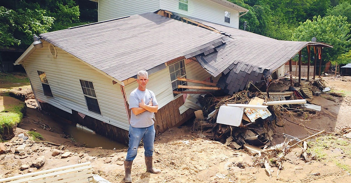 Eddie Fields in front of his flooded and damaged home in Pie, West Virginia.  |  Logan Banner File Photo.